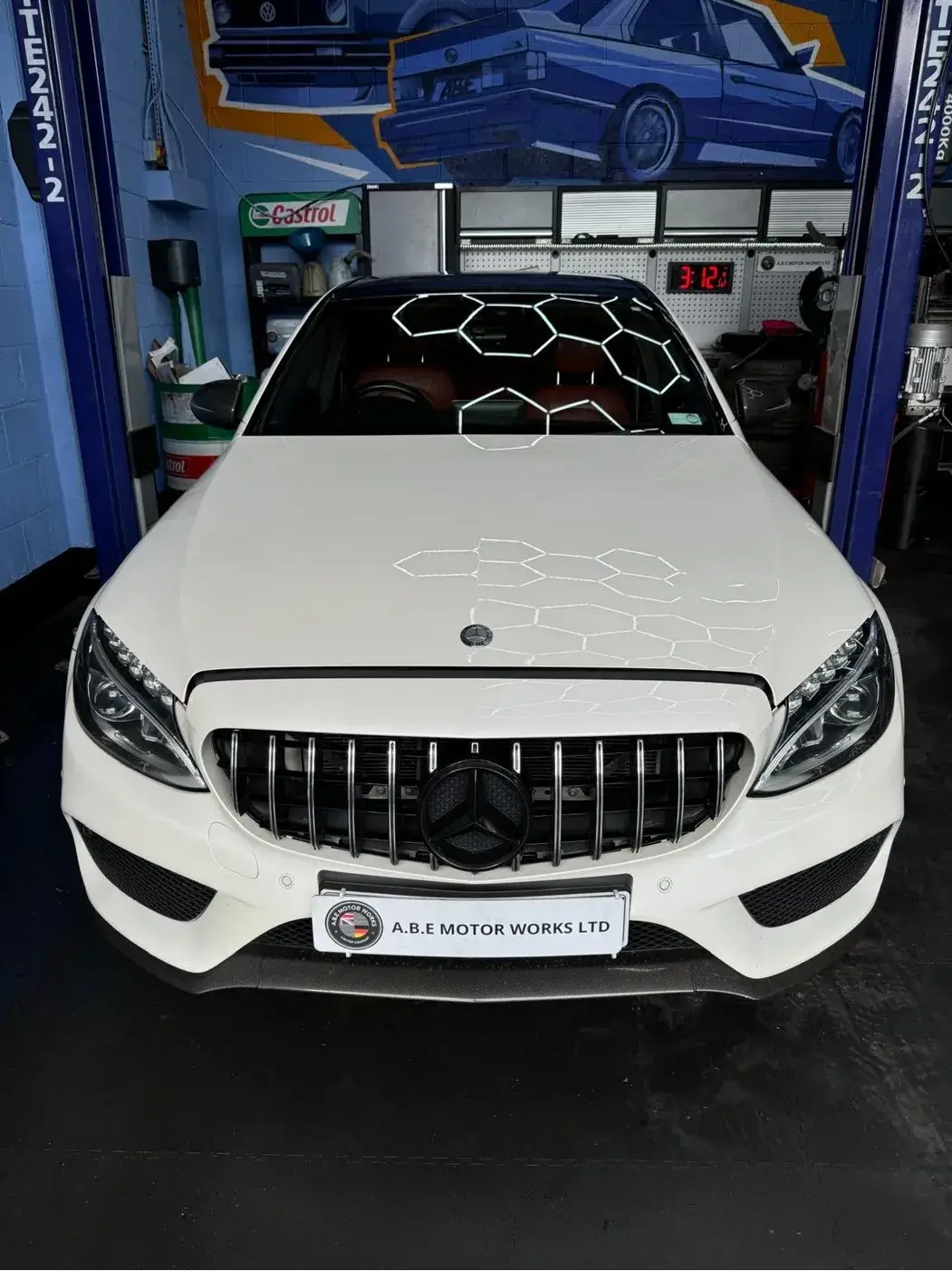 a close up of a white car with a sticker on it
