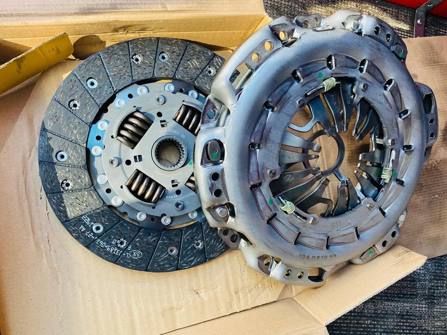 A close up of a clutch on a cardboard box.